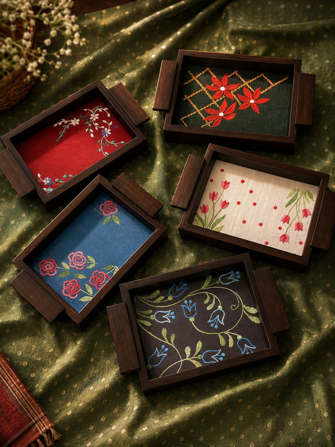 Aavo hand embroidered small serving trays grouped on green fabric