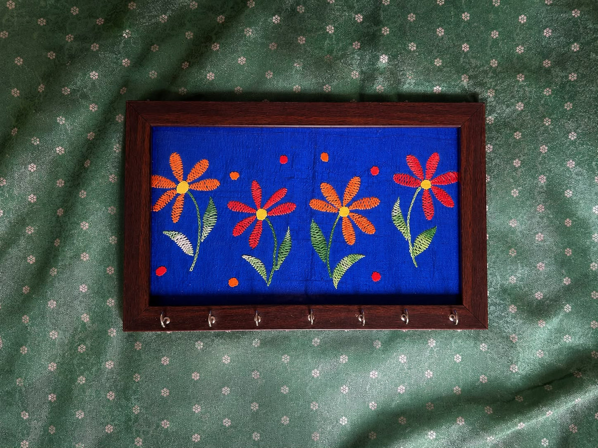 hand embroidered raw silk key holder in a wooden frame, blue