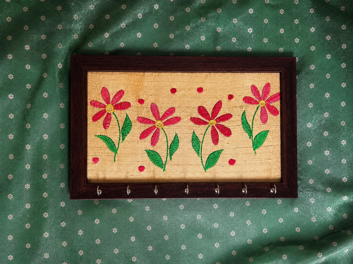 hand embroidered raw silk key holder in a wooden frame, yellow