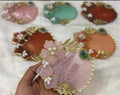 Handcrafted resin coaster platters in pink, teal and terracotta with gold-leaf and pearl accents
